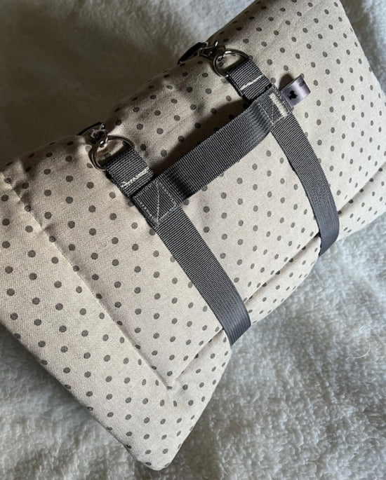 handmade folded settle mat in grey polka dot with a carry wrap strap 