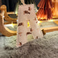 Small Christmas tree with animal pattern on a wooden surface