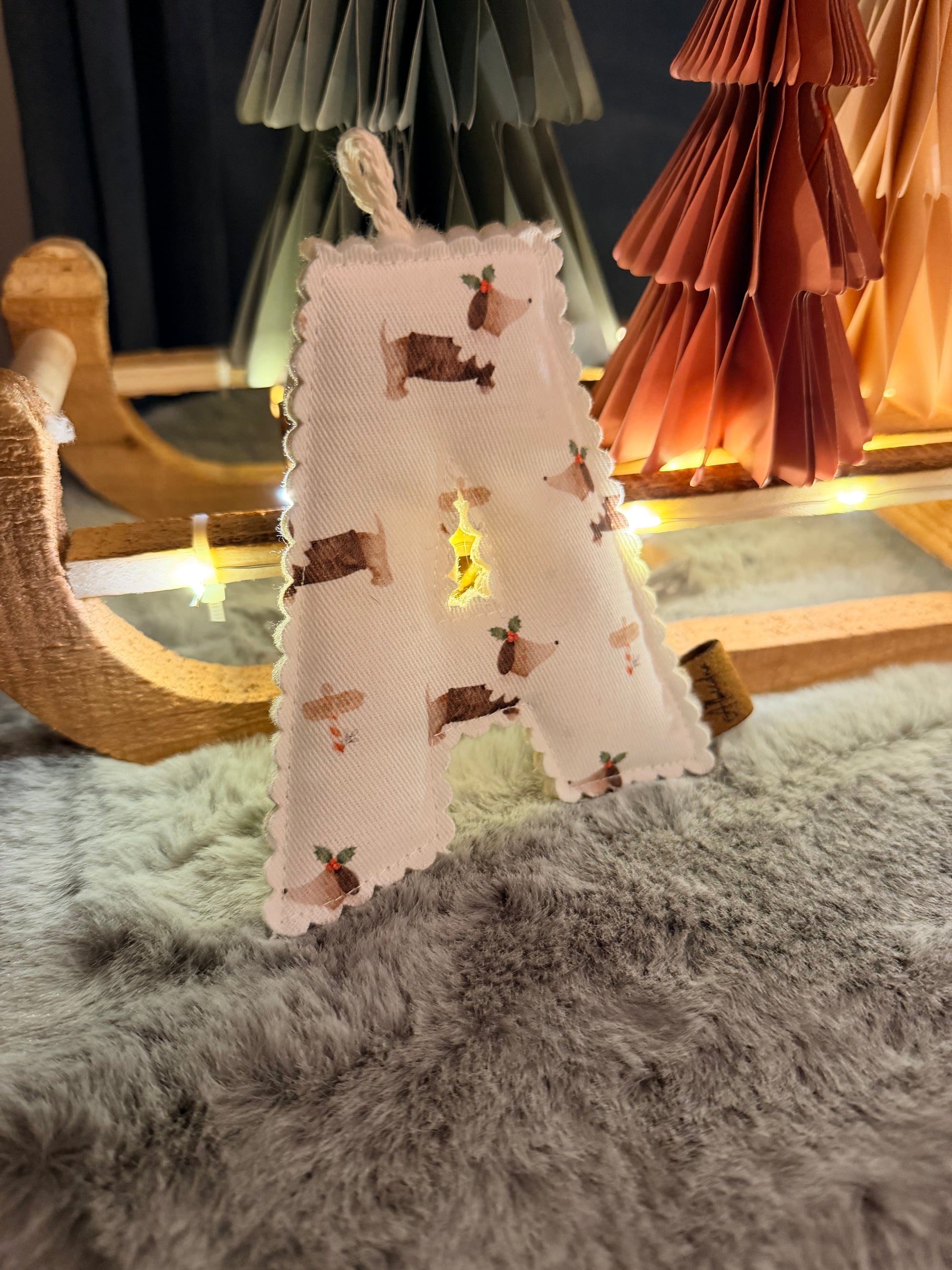 Small Christmas tree with animal pattern on a wooden surface