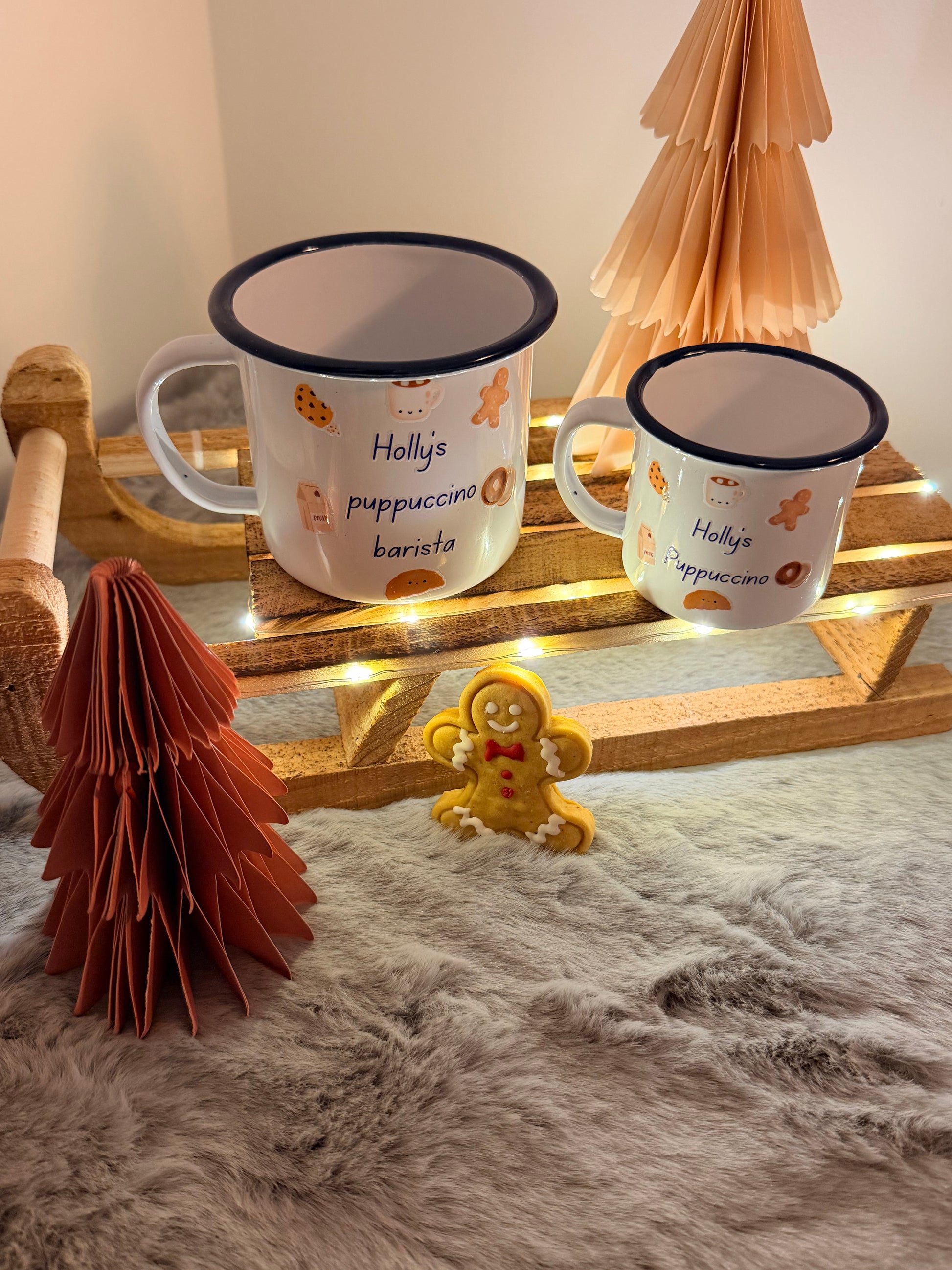 Two mugs with decorative elements on a wooden stand against a soft, textured background.