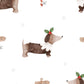 Pattern of dachshunds with Christmas pudding dressed sausage dogs decorations on a white background