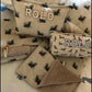 two cushions, a blanket and crate cover in linen cotton with dachshund print reading ROLO