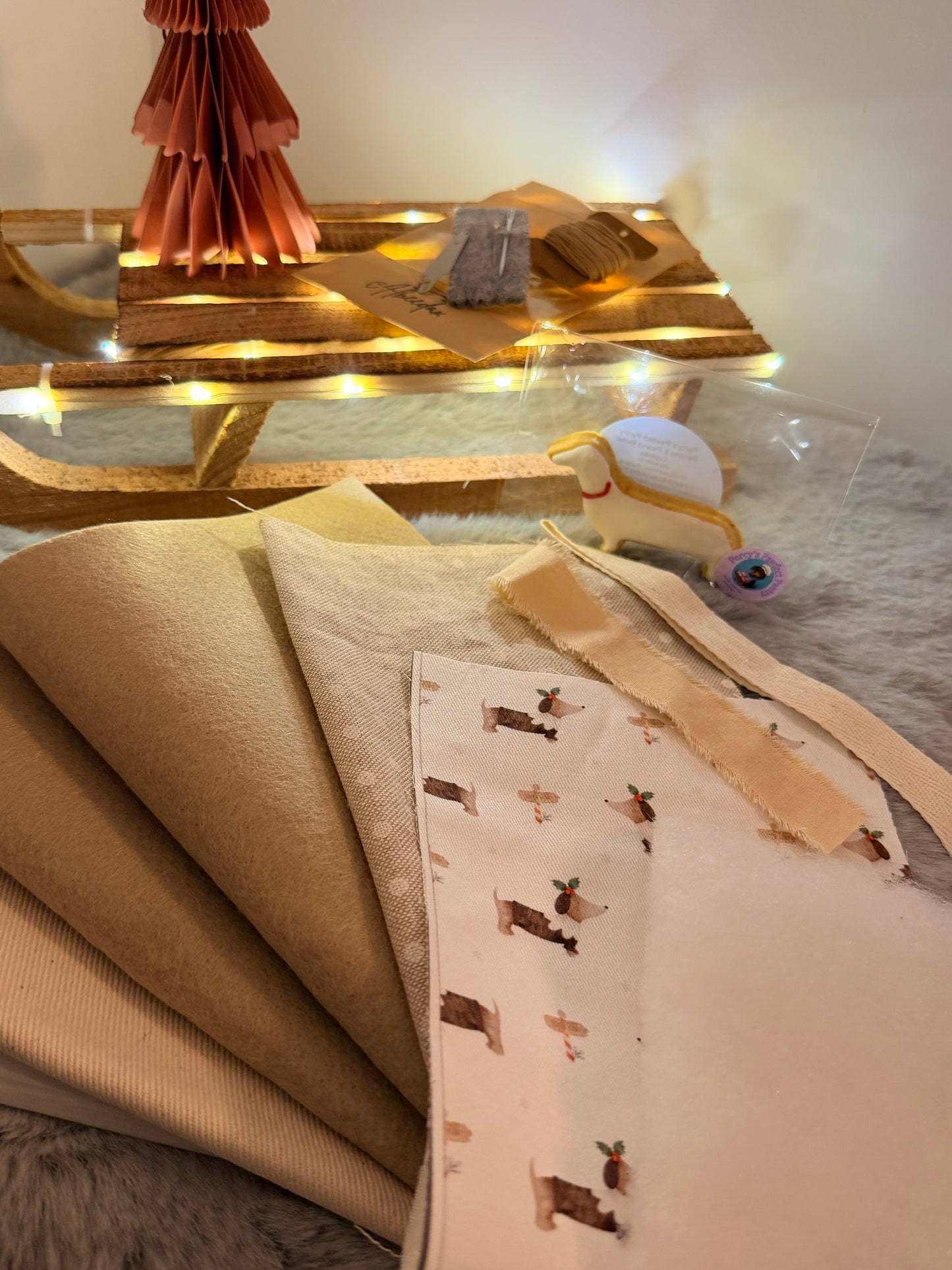 Decorative pillow with a pattern on a bed with fairy lights