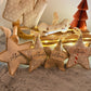 Decorative star-shaped ornaments with 'Albeedax' text on a soft surface.