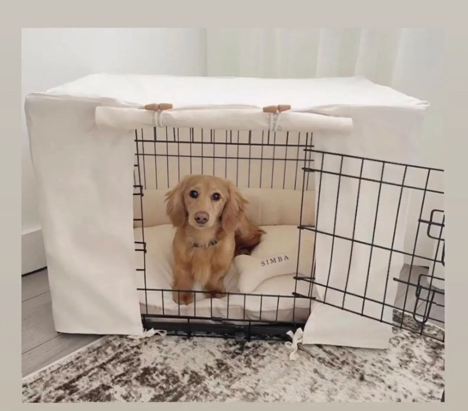 Long haired dachshund in a natural dog crate set  with a personalised toy bone